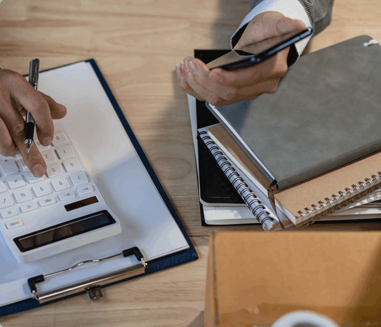 Business professional using calculator and phone