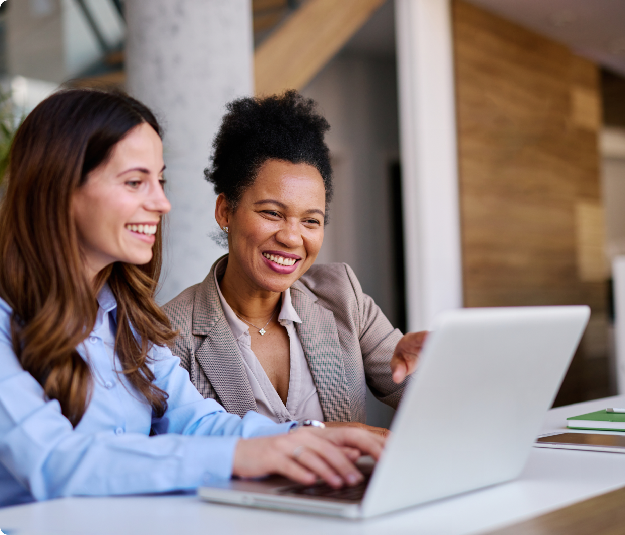 Two women collaborating on a laptop